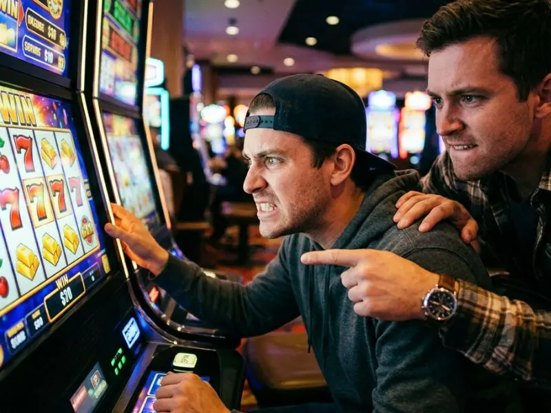 Milton 888 online casino buddy watching slot screen with intense focus, anticipating a win